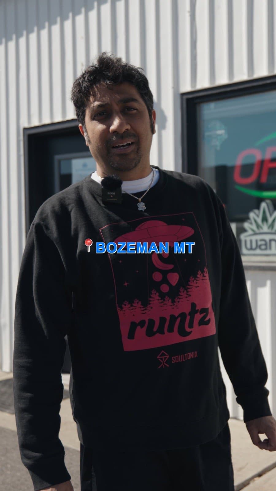 Budtender in a Bozeman sweatshirt walking the sales floor at Euphoria Wellness