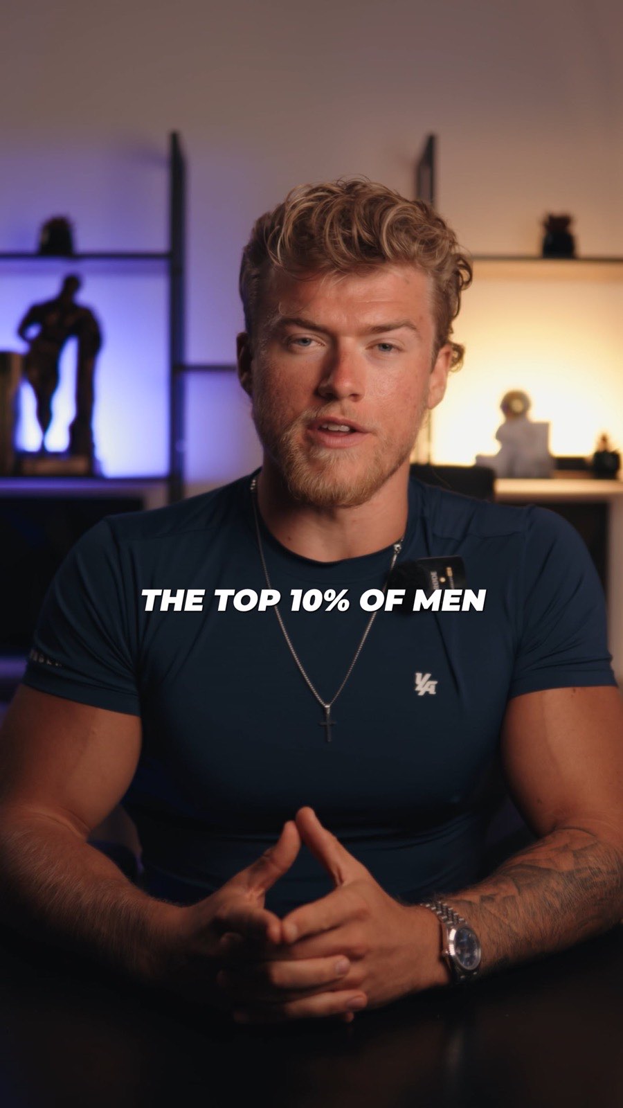 Brandon Clark seated in front of a lit shelf unit, on-screen caption reading The top 10% of men
