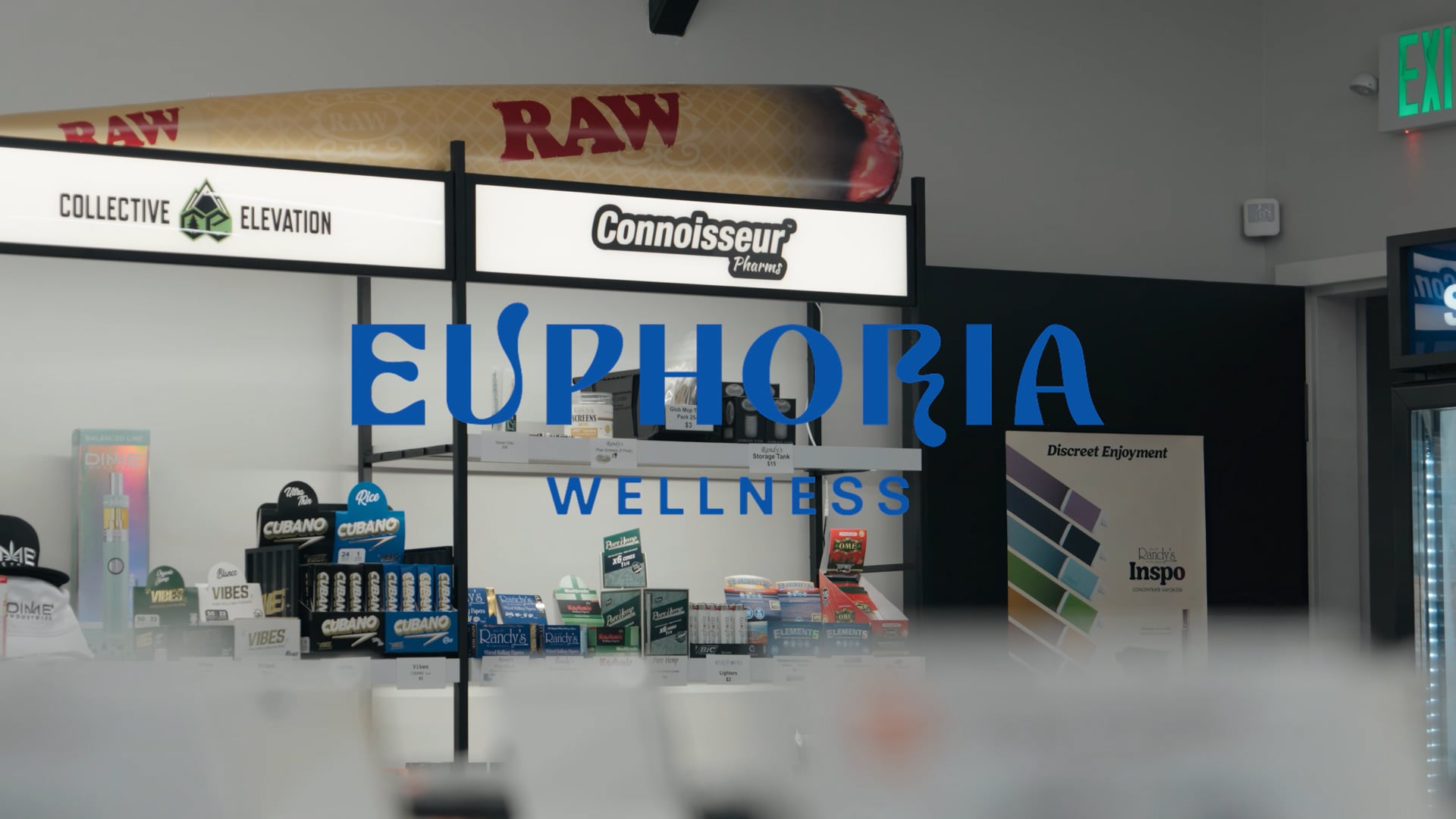 Euphoria Wellness dispensary counter with the blue brand sign on the back wall and product cases in front