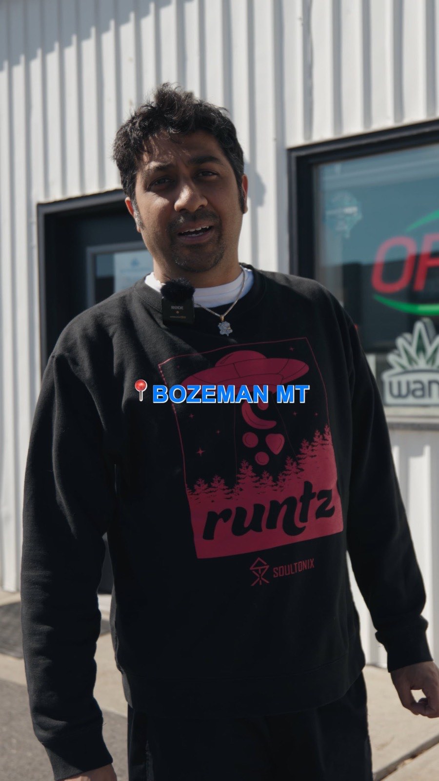 Budtender in a Bozeman sweatshirt walking the sales floor at Euphoria Wellness