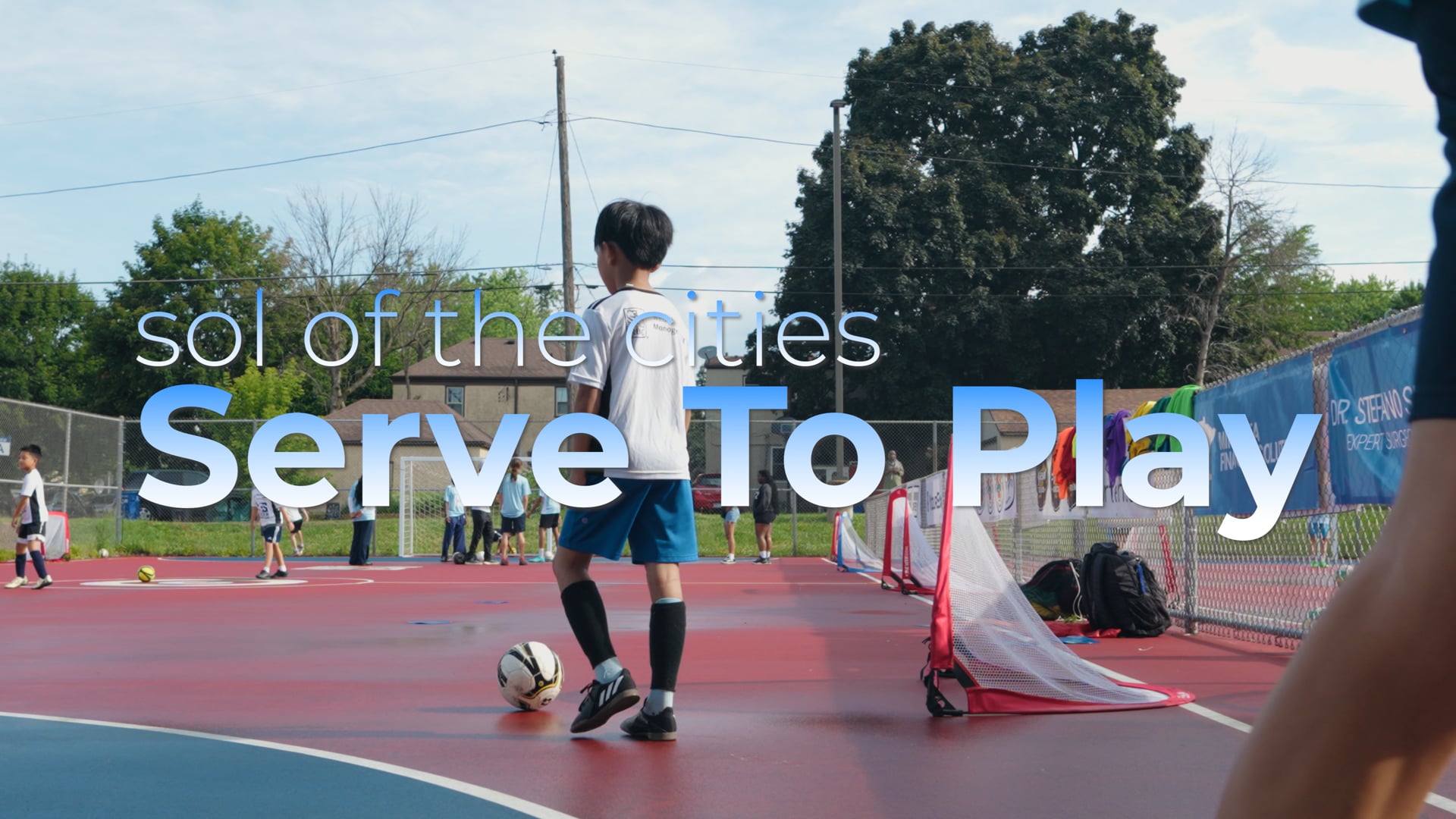 Player kicking a ball on an outdoor court under the Serve To Play title card